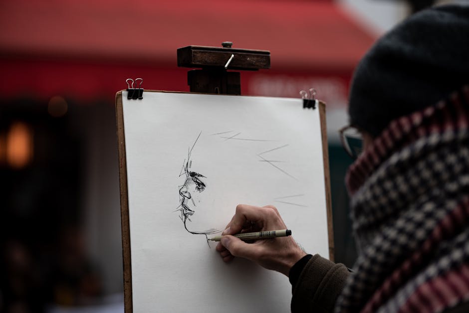 An artist draws a portrait on paper in a charming Paris street scene, showcasing creativity.