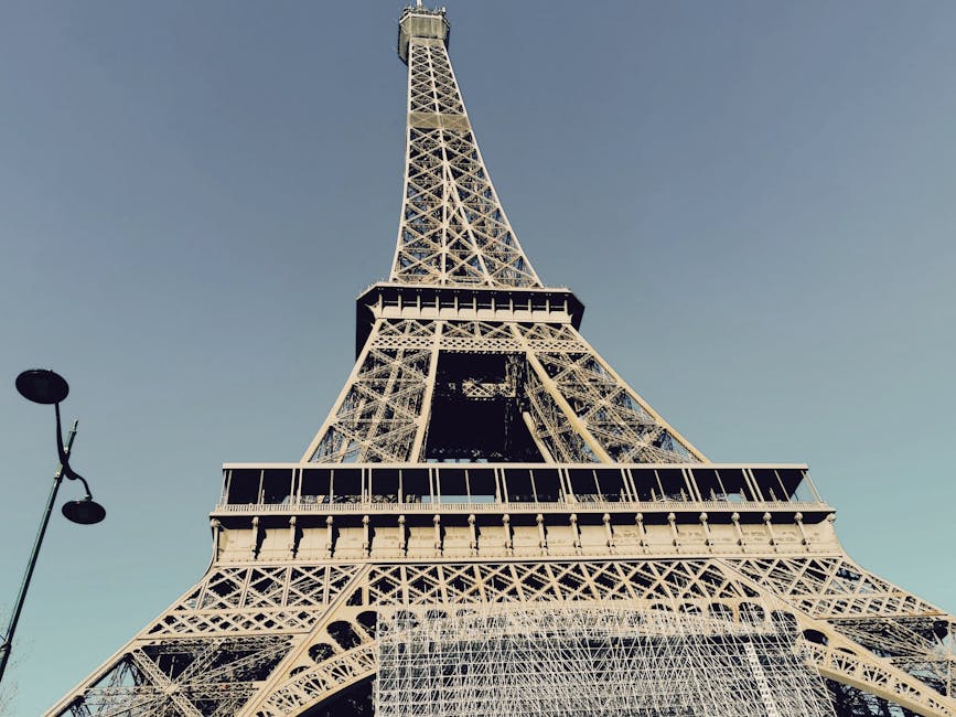 A stunning low-angle view of the Eiffel Tower in Paris, capturing its architectural majesty.