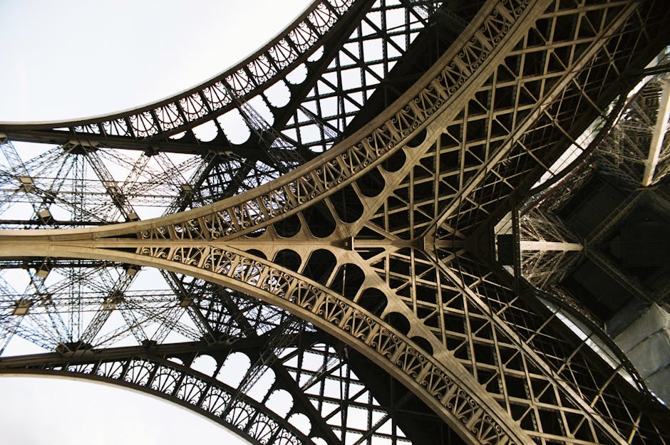 A detailed view of the Eiffel Tower's intricate ironwork from beneath, capturing the architectural marvel.